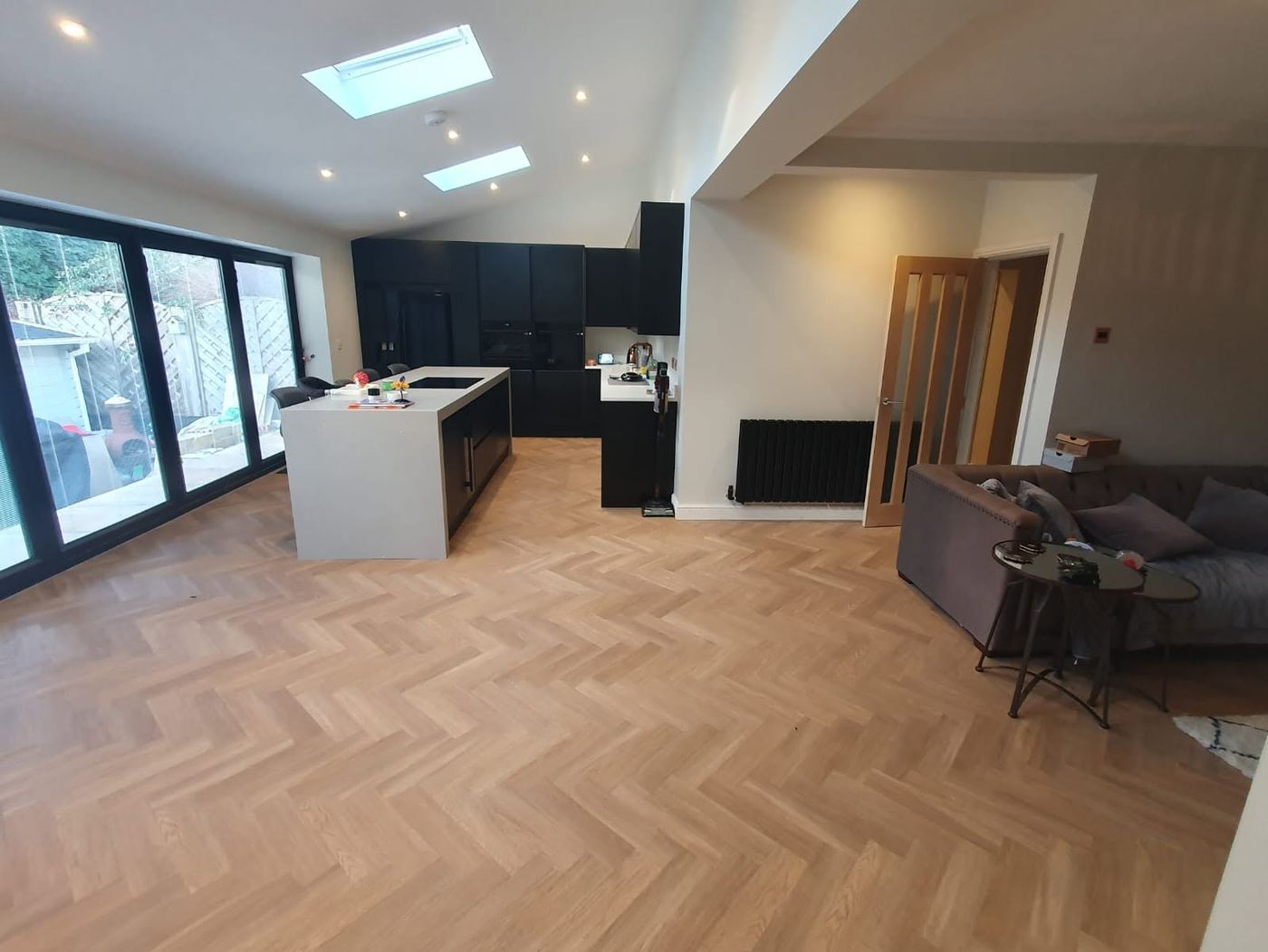 Open-plan extension with herringbone flooring by PJB builders in Bolton