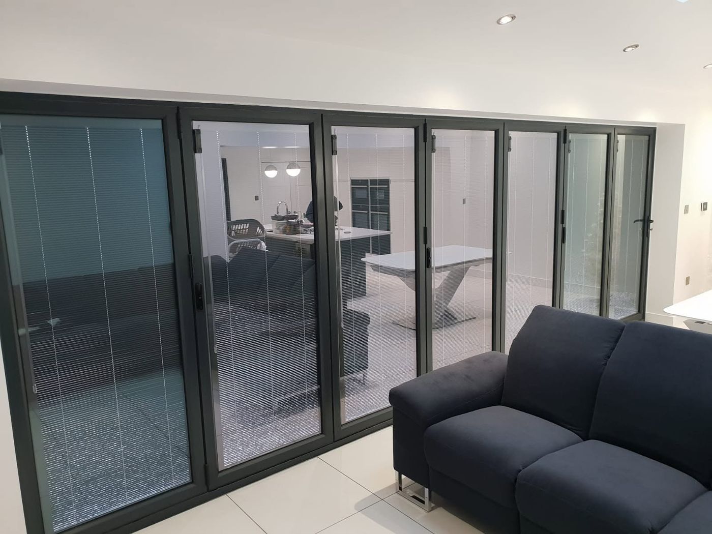 Bi-fold doors opening to the garden with oak flooring, fitted by PJB