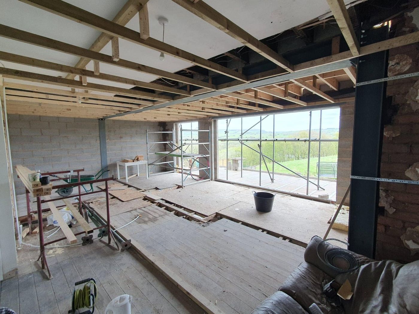 Large extension under construction with full-width glazing and countryside views