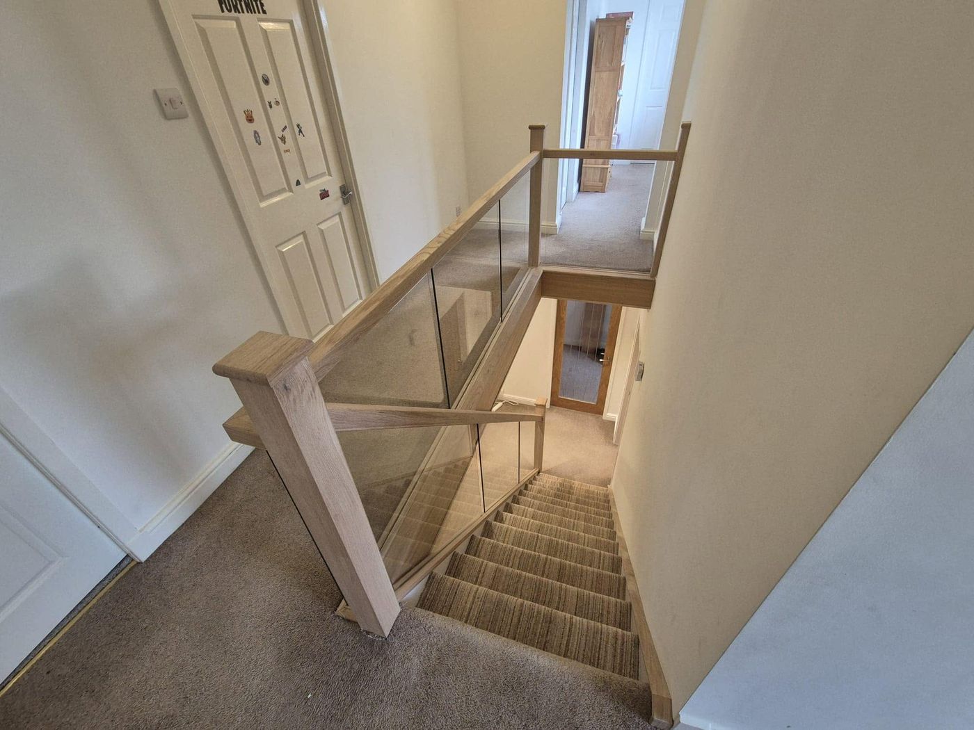 Oak staircase with glass balustrade panels handmade and fitted by PJB